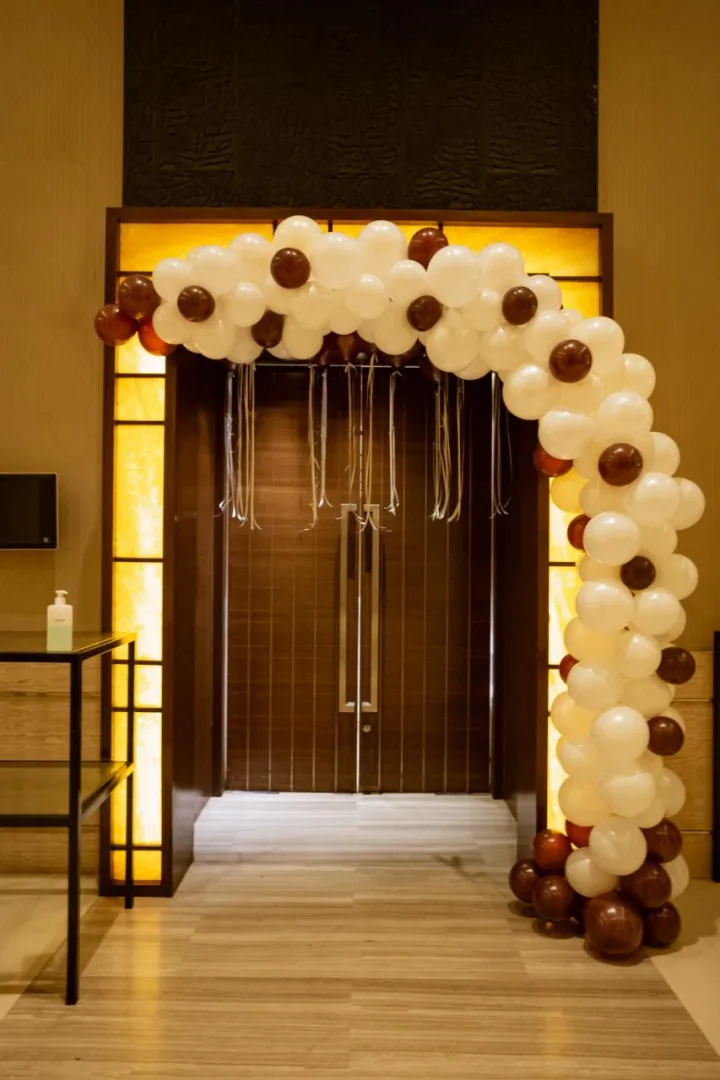 Balloon arch framing a doorway at home — event by Plan With YOLO, Pune