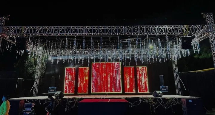 Truss, lighting and backdrop panels rigged for a stage show — event by Plan With YOLO, Pune