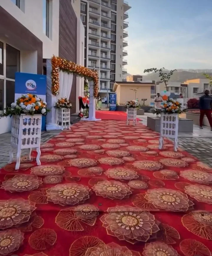 Floral entrance and red carpet at a project launch — event by Plan With YOLO, Pune