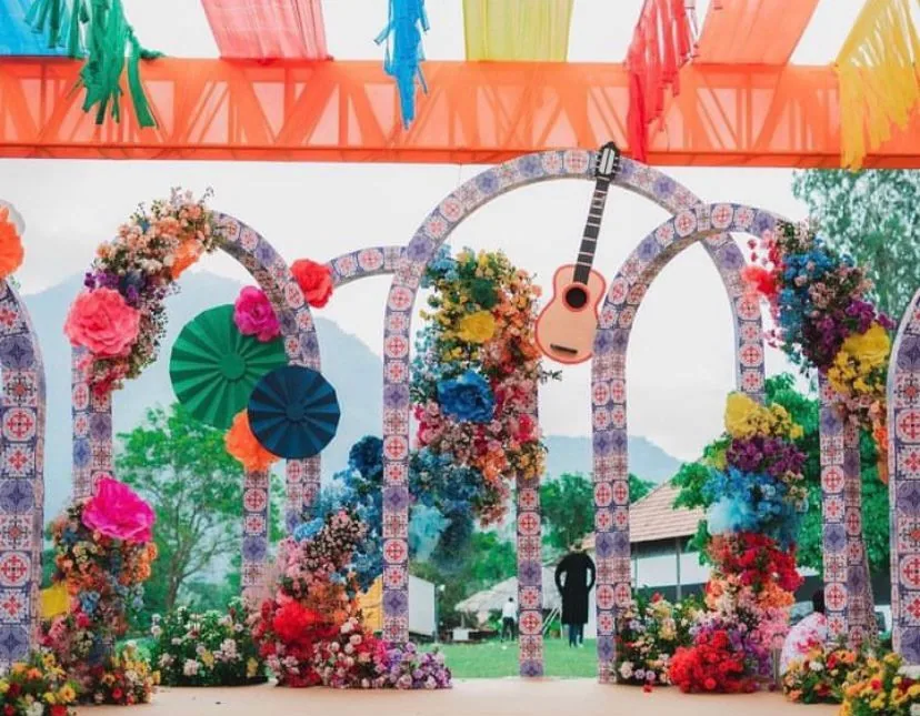 Paper-craft arches in bright colours with fans and a guitar for a festival set — event by Plan With YOLO, Pune