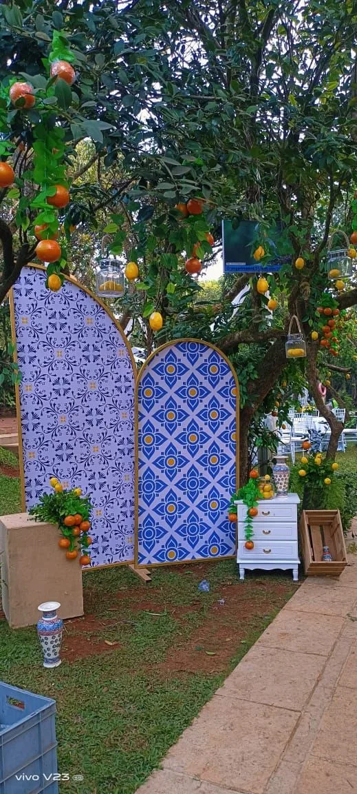 Tiled backdrop photo corner under a tree — event by Plan With YOLO, Pune