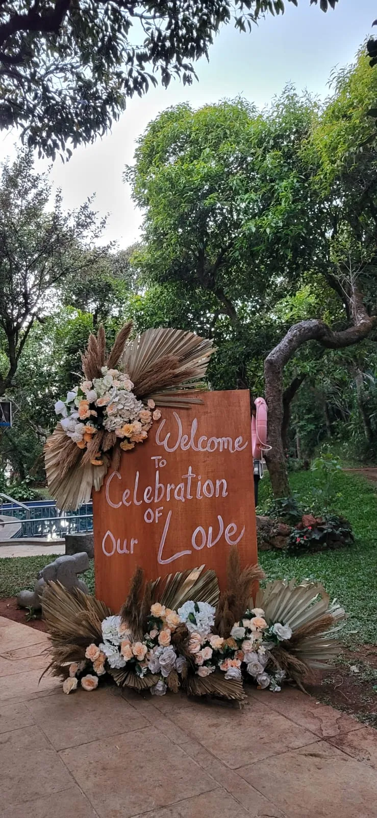 Hand-lettered welcome board at the entrance — event by Plan With YOLO, Pune
