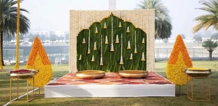 Haldi setup on a lawn, banana leaf and brass — event by Plan With YOLO, Pune