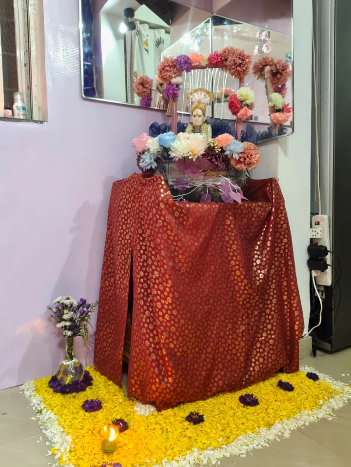 Gauri decoration at home, red drape and marigold — event by Plan With YOLO, Pune