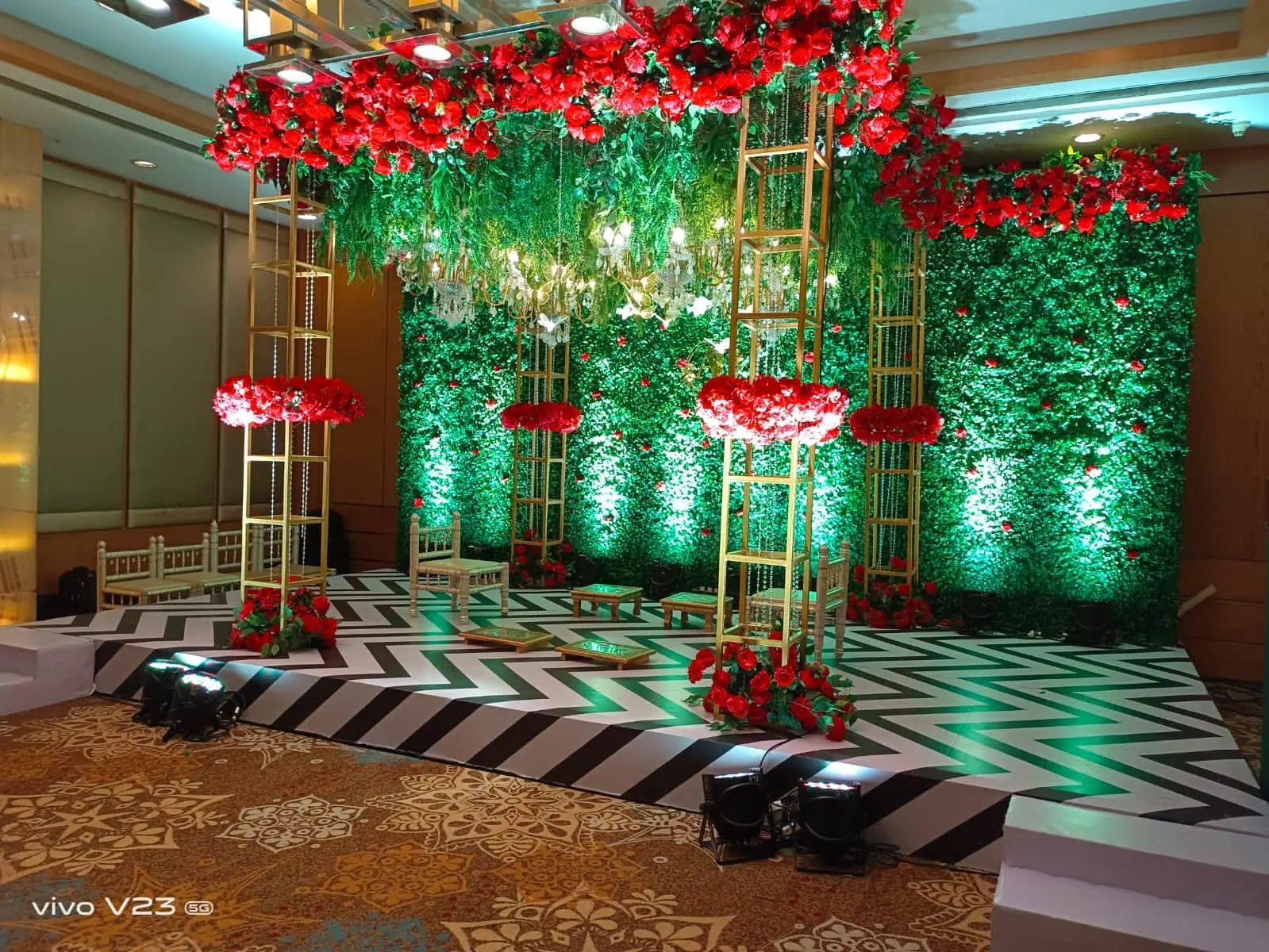 Green floral stage decor — event by Plan With YOLO, Pune