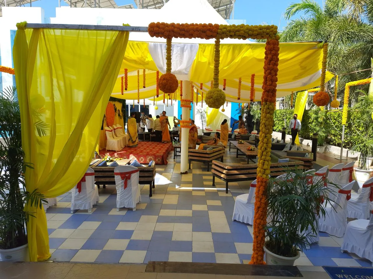 Yellow drapes and marigold beside the pool — event by Plan With YOLO, Pune