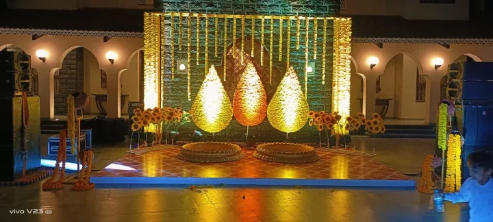 Sunflowers and gold drapes for a haldi stage — event by Plan With YOLO, Pune