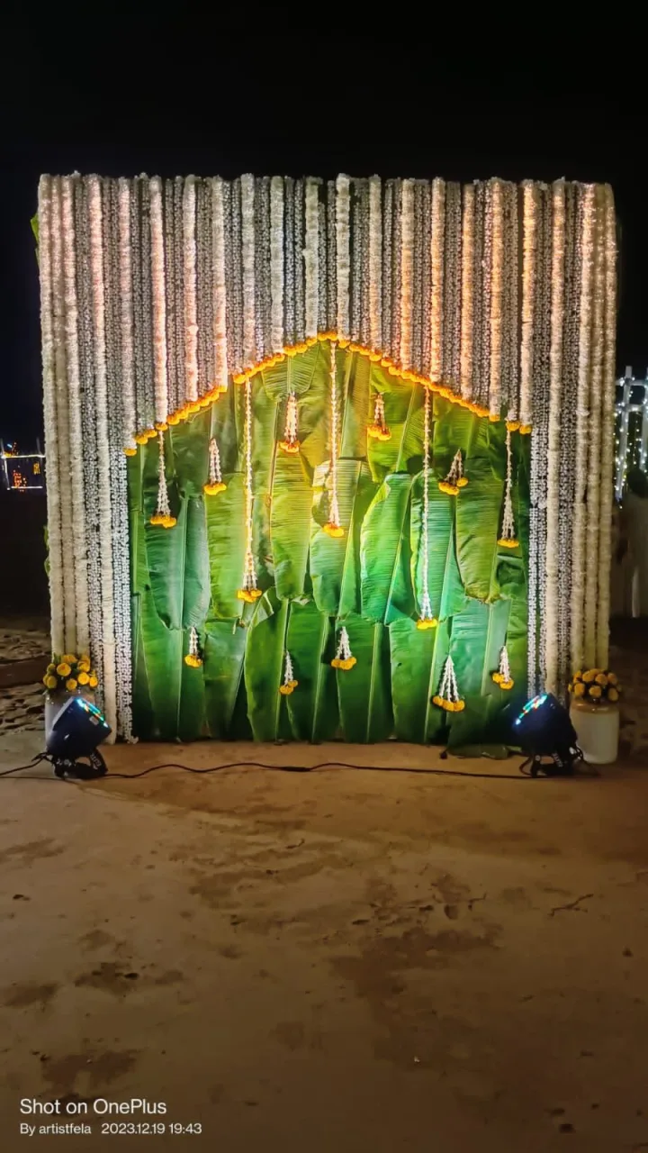 Leaf backdrop under fairy lights — event by Plan With YOLO, Pune