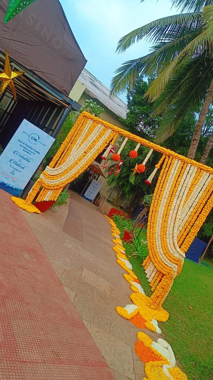 Yellow drape arch on a lawn — event by Plan With YOLO, Pune