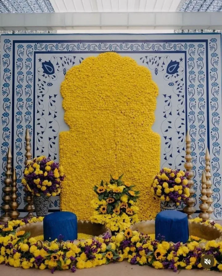 Marigold wall against a blue tile backdrop — event by Plan With YOLO, Pune