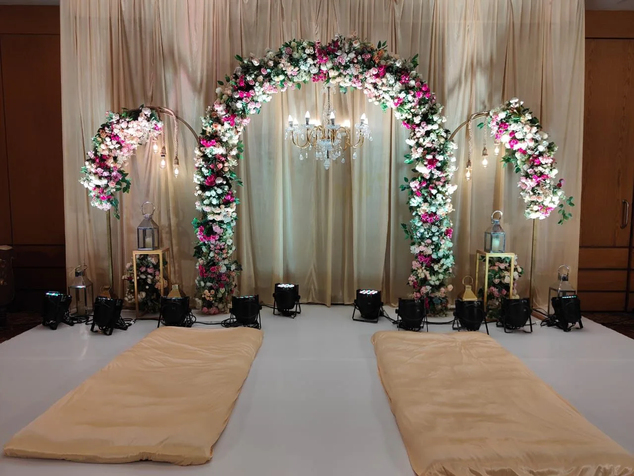 Floral arch and chandelier over the aisle — event by Plan With YOLO, Pune