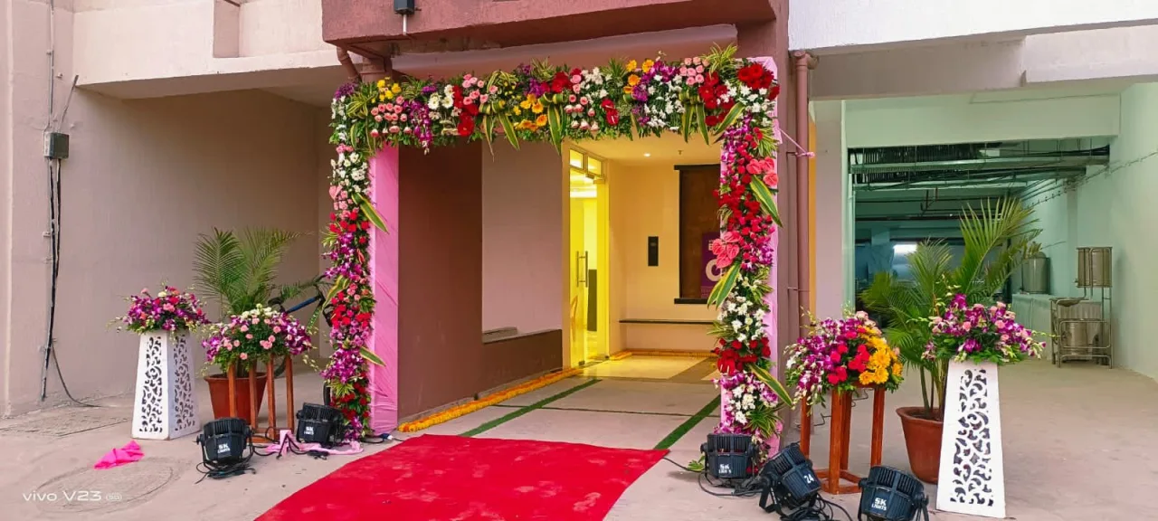 Entrance florals and red carpet at home — event by Plan With YOLO, Pune