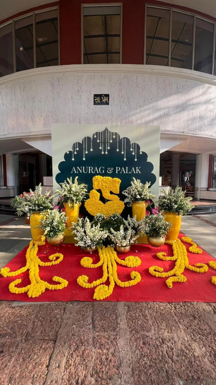Wedding entrance in marigold with a welcome board — event by Plan With YOLO, Pune