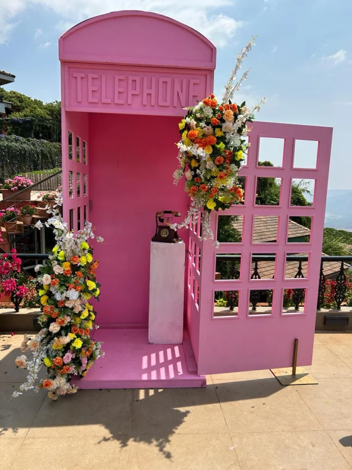 Telephone-box photo corner for a wedding lawn — event by Plan With YOLO, Pune