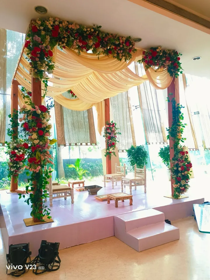Mandap with greenery on the pillars — event by Plan With YOLO, Pune