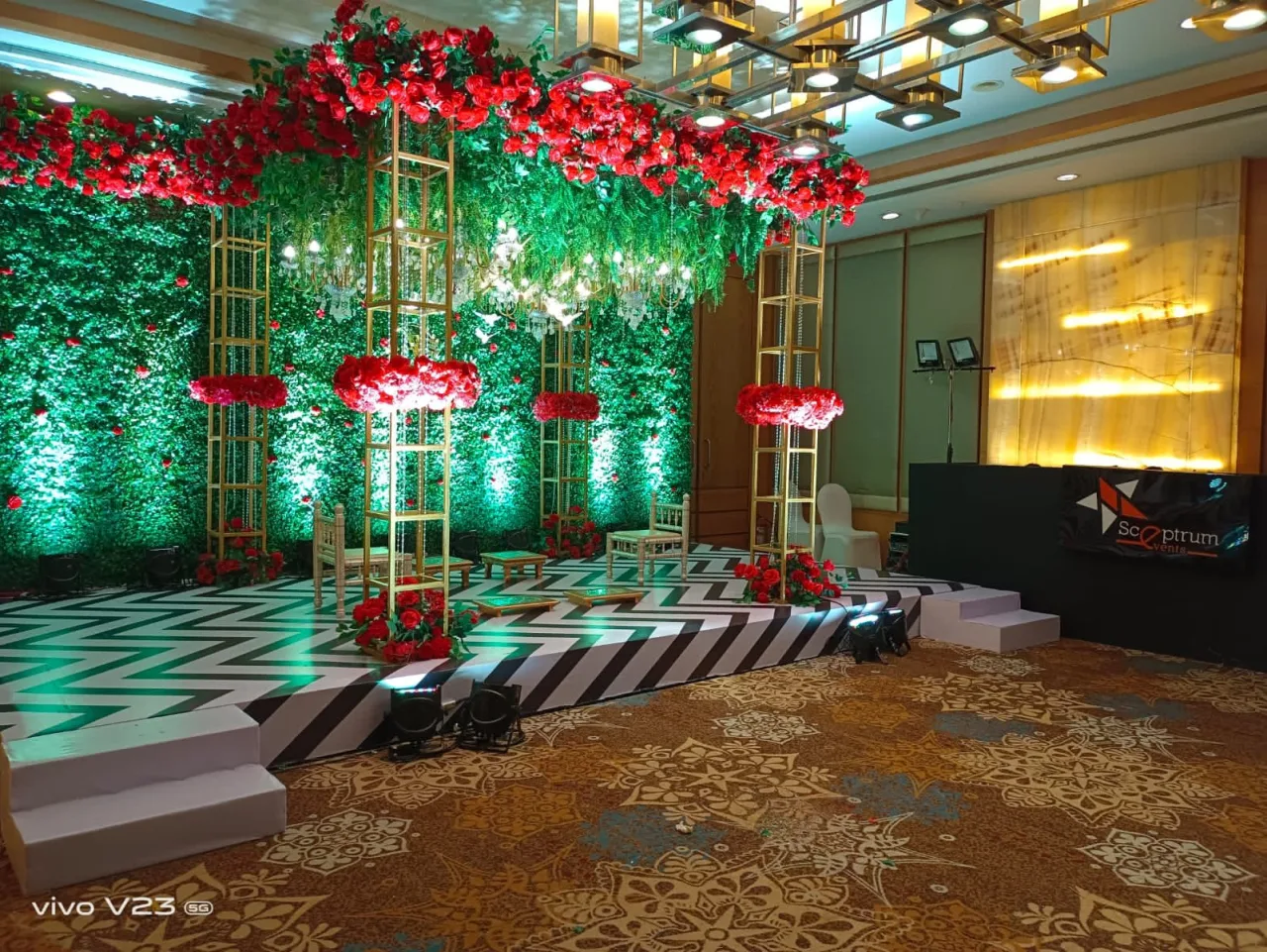 The foliage wall and roses, seen wide — event by Plan With YOLO, Pune