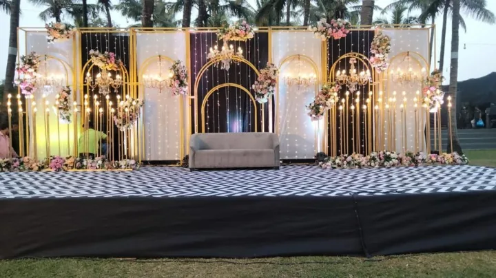 Reception stage at dusk, lights on — event by Plan With YOLO, Pune
