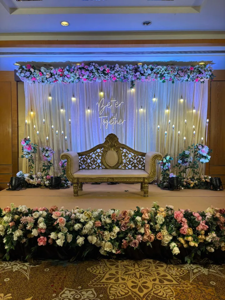 White drape and florals on a banquet stage — event by Plan With YOLO, Pune