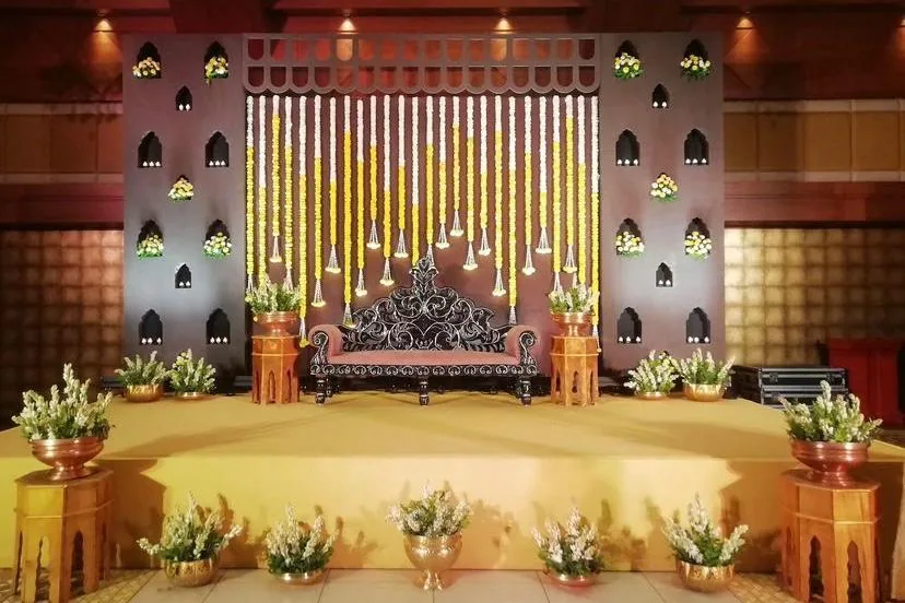 Hanging strings and gold for a wedding stage — event by Plan With YOLO, Pune